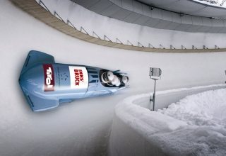 Vibe Teachers riding a bobsled in Austria 