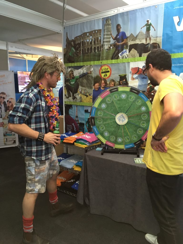 Bogan Bingo and vibe teaching spinning the wheel at the TNT Travel show