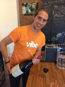 Vibe Teaching Agencies Jack pouring the wine at Vibe HQ in London